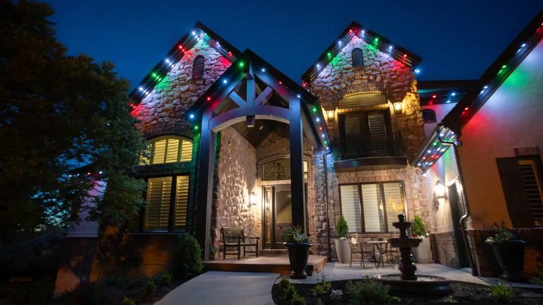 Home lit in color with permanent roofline lights