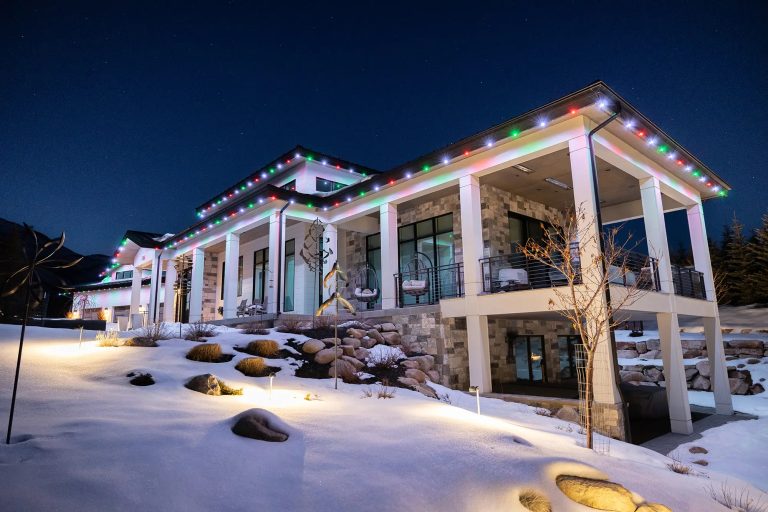 Home lit for the holidays with permanent roofline lights