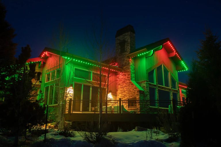 Home lit for the holidays with permanent roofline lights