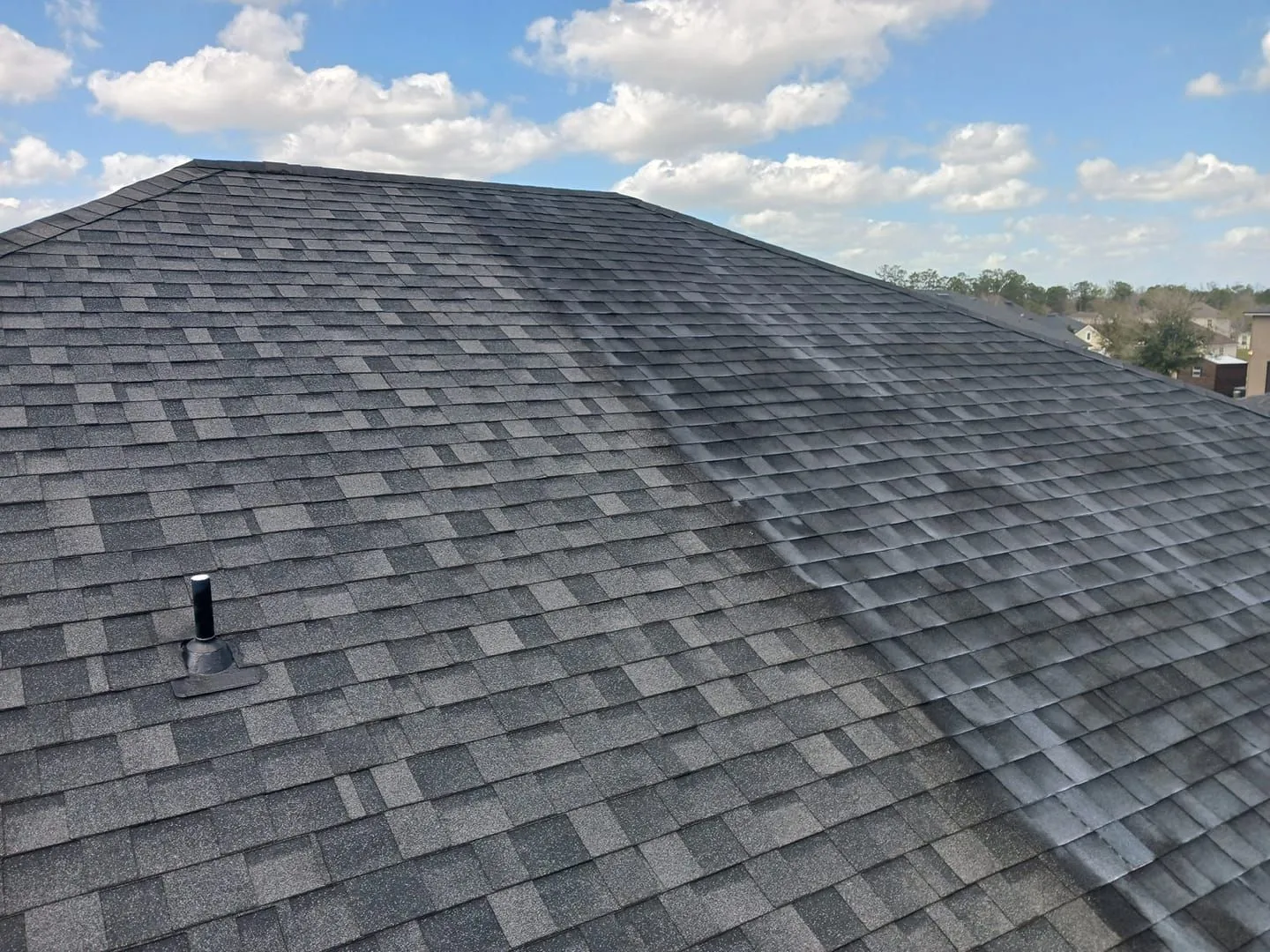 Roof life extension treatment being applied to an asphalt shingle roof