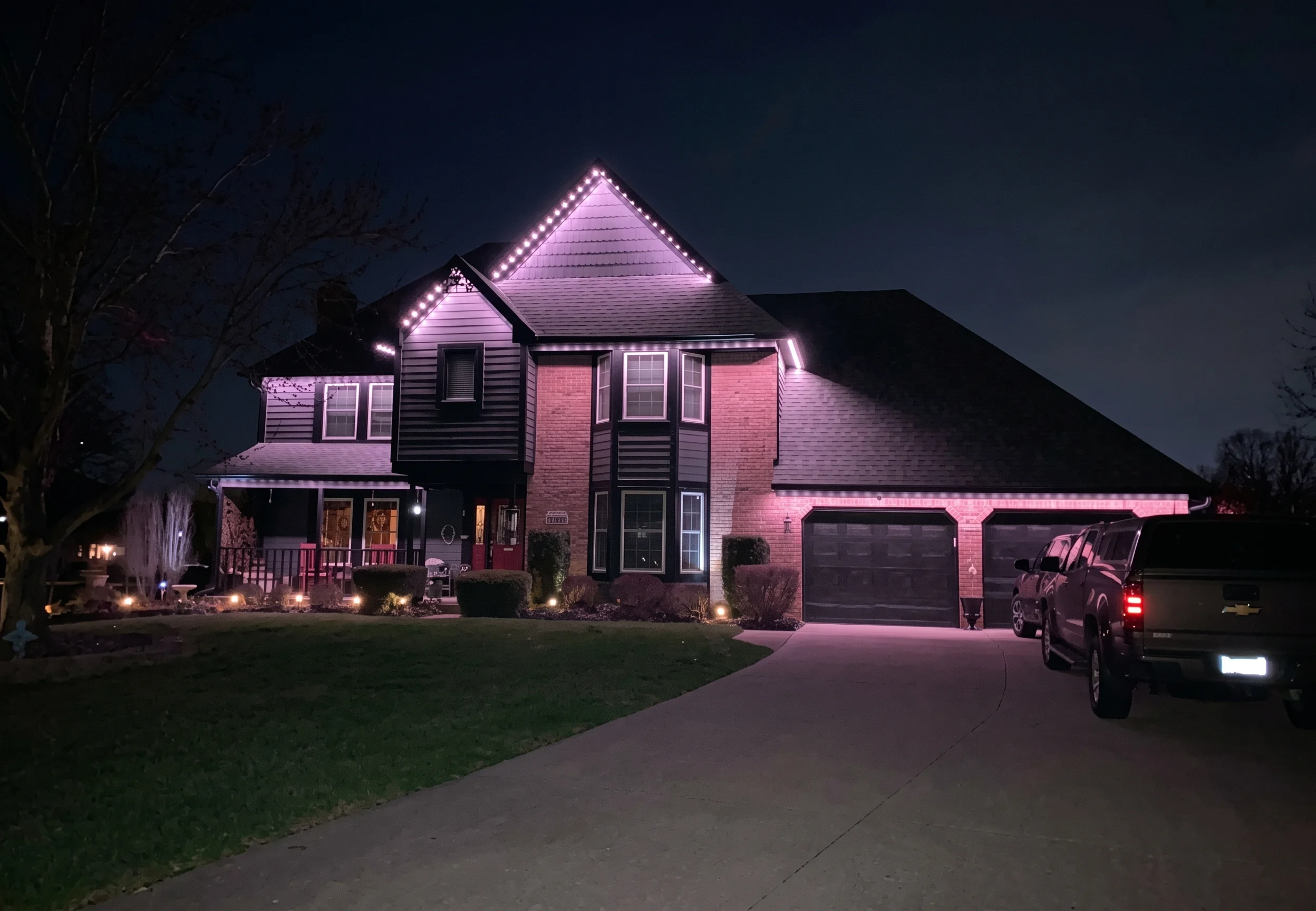 Soft warm accent glow along the eaves of a home