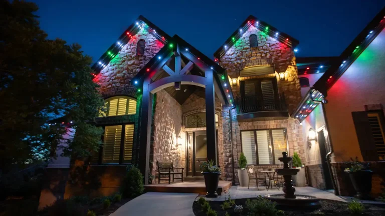 Home lit in color with permanent roofline lights