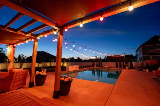 JellyFish hanging patio lights and standing landscape lights around a pool
